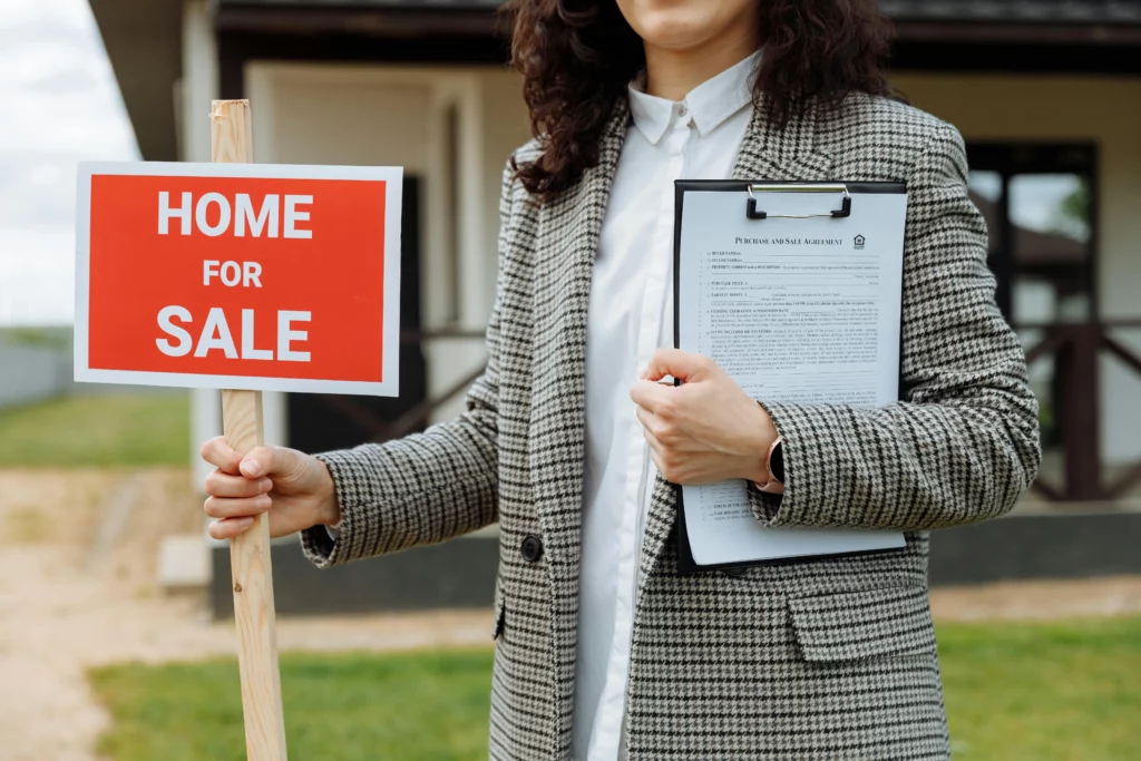 Photo by Thirdman httpswww.pexels.comphotoclose-up-of-a-woman-holding-a-home-for-sale-sign-8469937